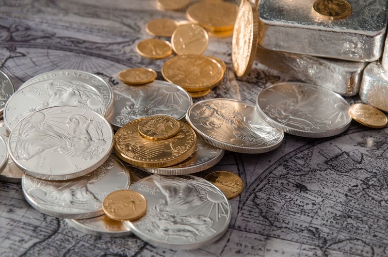Silver bars with gold and silver bullion coins on an old map at a Philadelphia bullion appointment