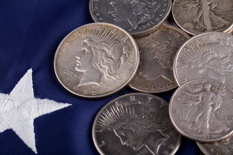 Peace and Morgan silver dollars on a flag star, ready for a Philadelphia silver dollar appointment
